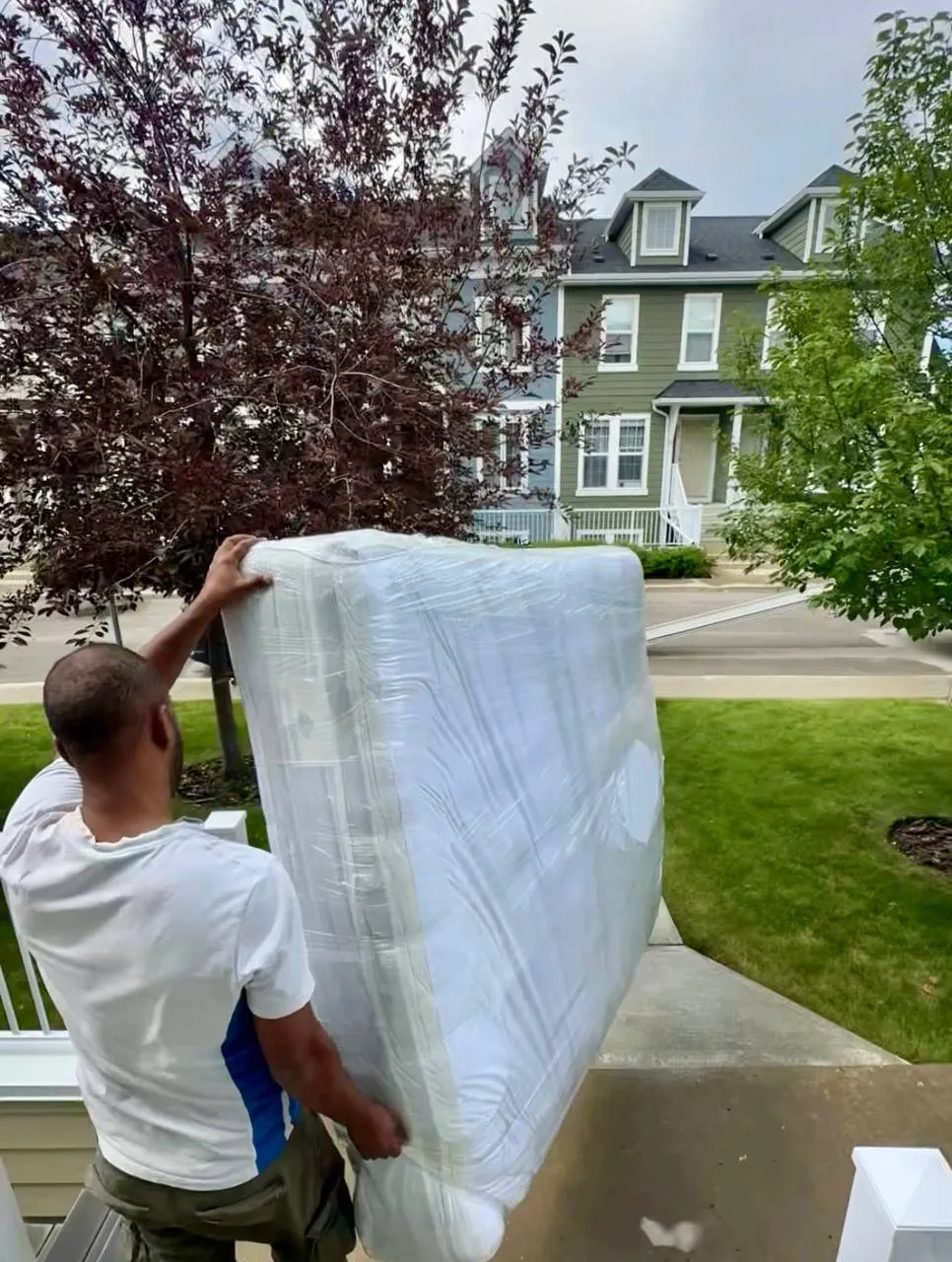 High Level Movers carrying wrapped household furniture during a North York home move